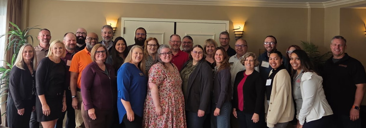 a large group of people standing in front of a wall