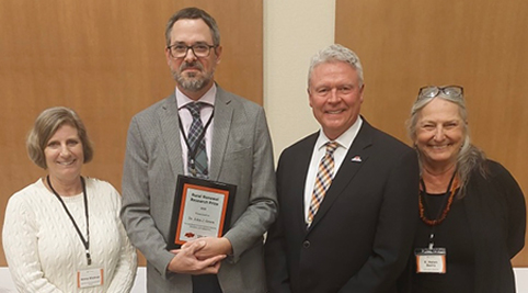 Photo of Dr. John Green, pictured with nominators, and OSU Vice President of ANR, holding his award plaque