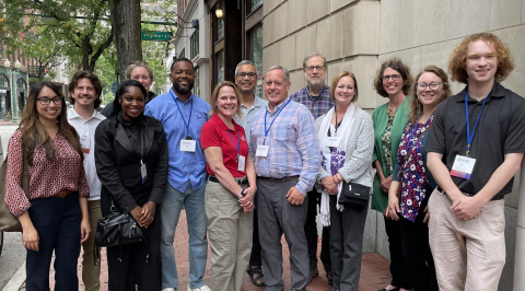 A group of people standing outside a building for a photo